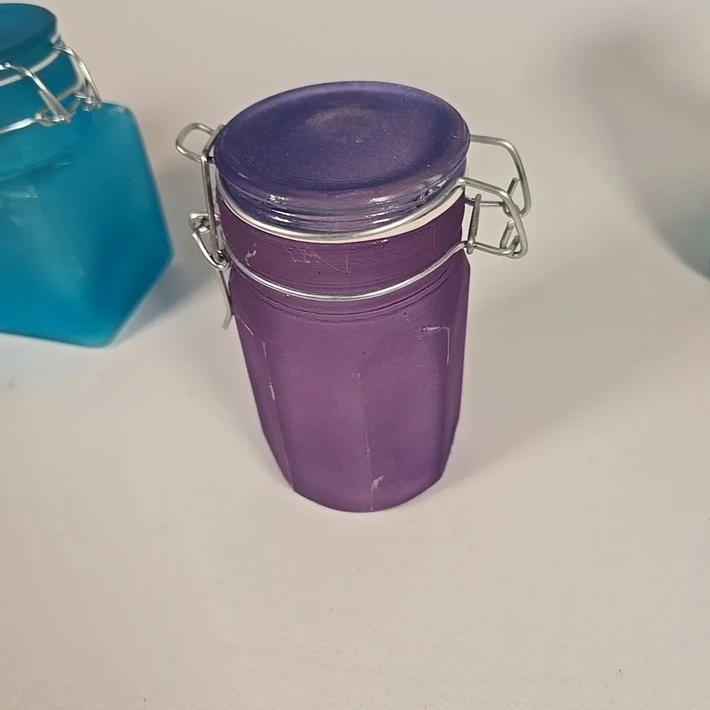 Set Of Four Colored‎ Glass Cannisters With Locking Tops Very Good Condition